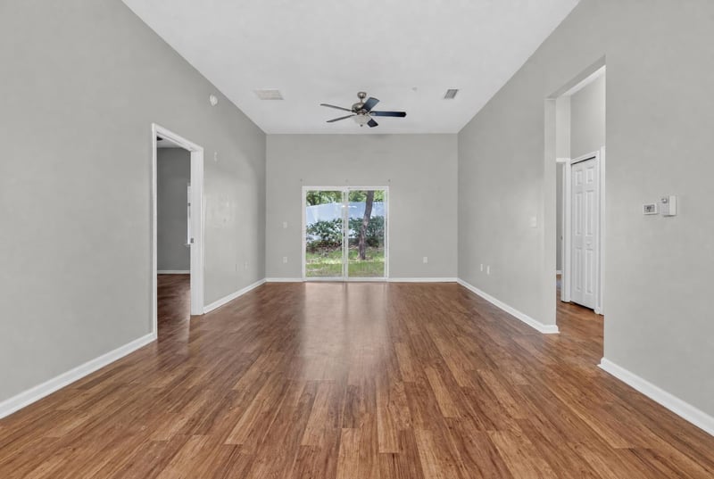 Open living area with window and wood-look flooring at 8196 Cabin Lake Cir, Jacksonville, FL 32256