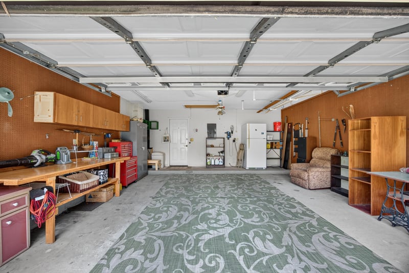 Garage with workbench and storage shelving at 4837 Pareja Ct, Jacksonville, FL 32225