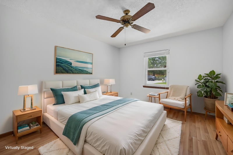 Bedroom staged with white and teal bedding at 2460 San Sago Ln, Jacksonville, FL