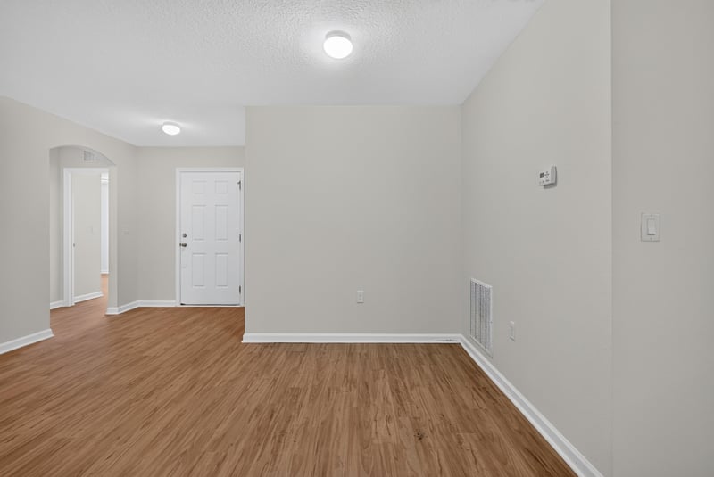 Hallway with white doors and wood flooring at 95221 Siena Ct, Fernandina Beach, FL 32034