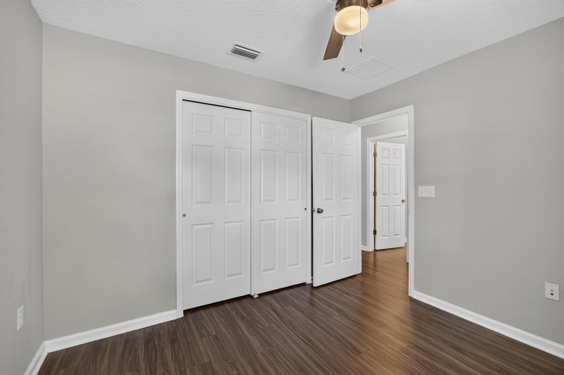 Bedroom with double closet doors at 7118 Preston Pnes Trl, Jacksonville, FL
