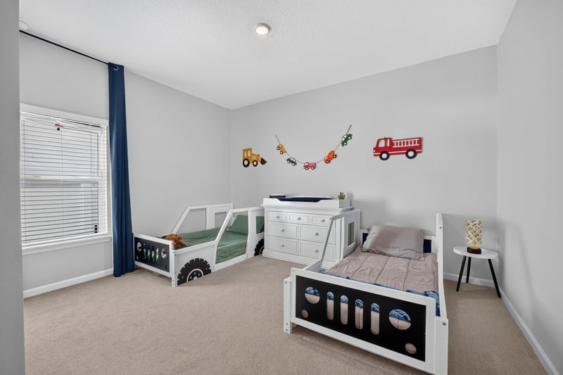 Bedroom with vehicle decals and toy chest at 2354 Jennings Farm Dr, Middleburg, FL 32068