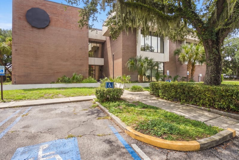 Corner of brick building with accessible parking space at 101 Scholars Wy
