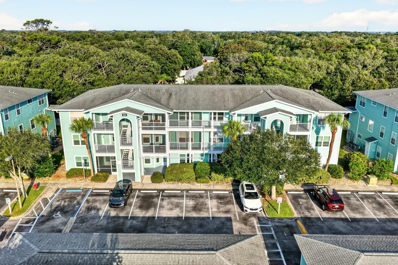 Aerial front view of the condo building with parking lot at 206 16th St, St. Augustine, FL 32080