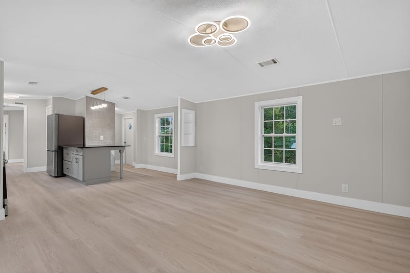 Open living room with vaulted ceiling and wood-look flooring at 4565 Appleton Ave, Jacksonville, FL