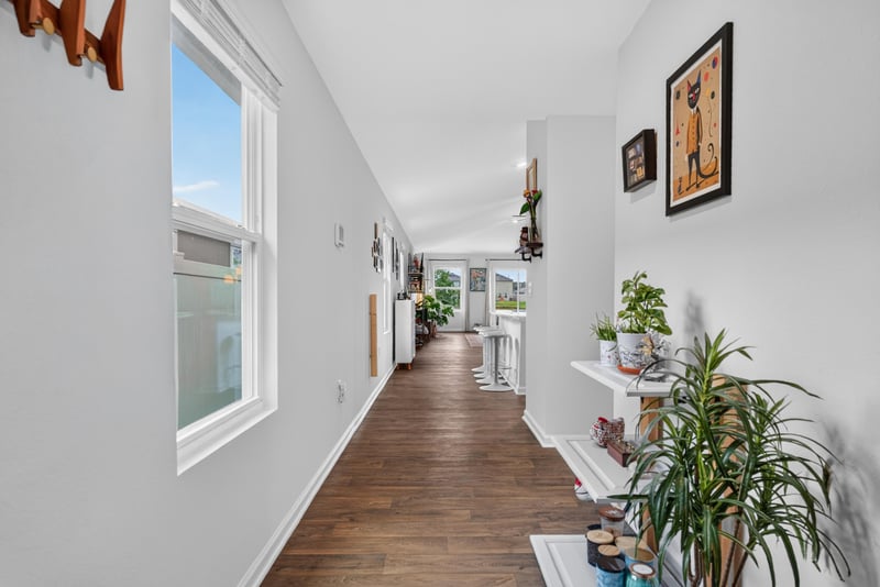 Entry hallway with wood floors and plants at 4276 Quaking St, Jacksonville, FL 32218