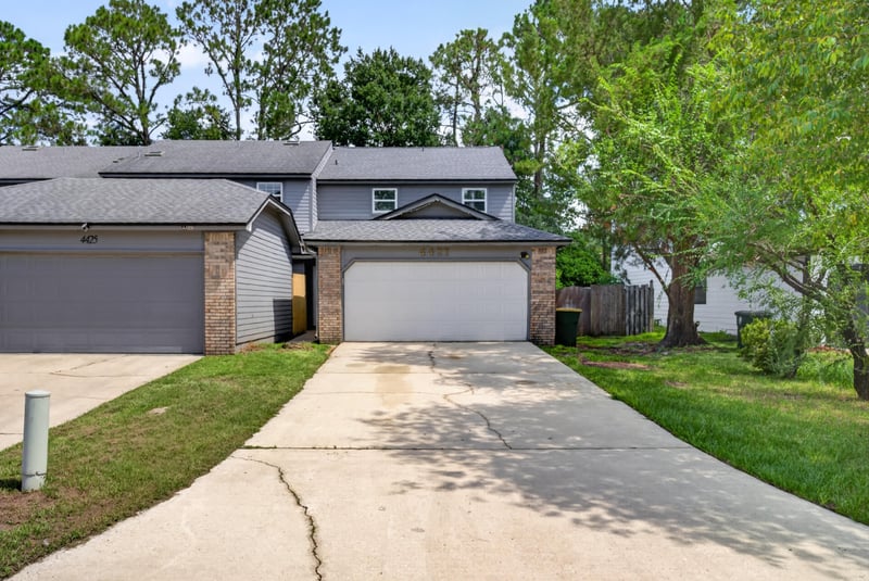 Front exterior with brick facade, attached garage and driveway at 4427 Millstone Ct, Jacksonville, FL