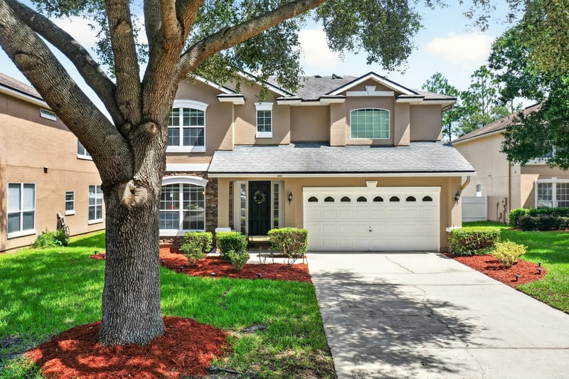 Front exterior with large oak tree and driveway at 3660 Middlebrook Dr, Orange Park, FL 32065