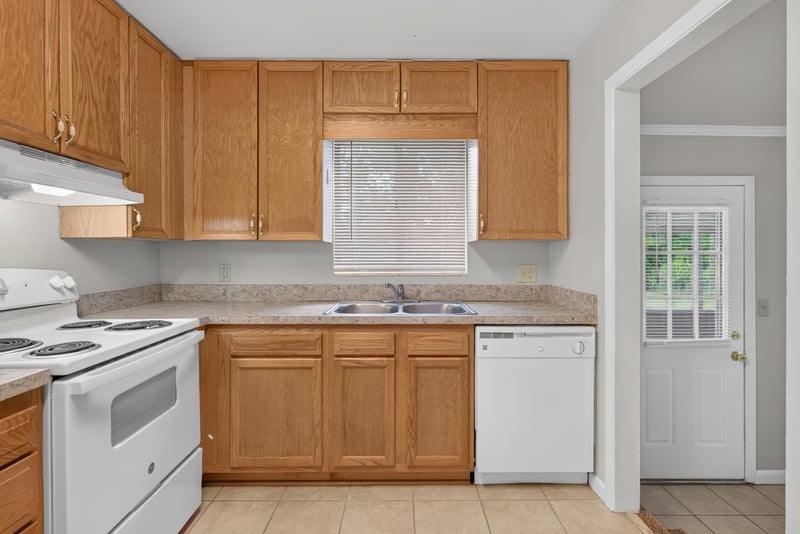 Kitchen with white range and oak cabinets at 2618 Arlex Dr E, Jacksonville, FL
