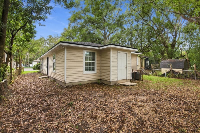 Side exterior with wooded lot and path at 219 Shortreed St, Jacksonville, FL 32254