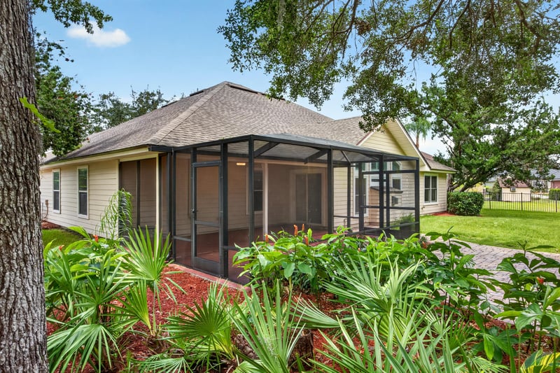 Aerial view of screened porch and backyard landscaping at 1955 GUARDED Way, Fleming Island, FL 32003