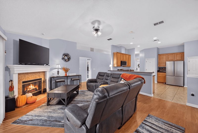 Family room open to kitchen with stainless fridge at 3112 Silverado Cir, Green Cove Springs, FL 32043