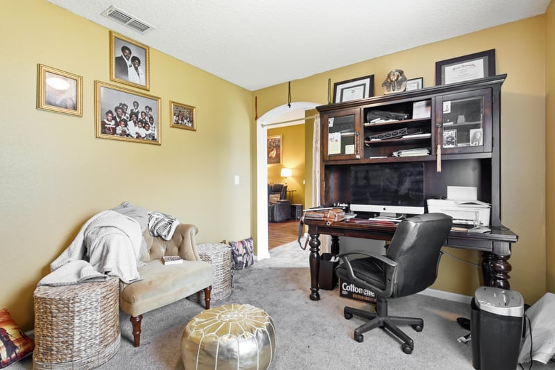 Home office with desk and built-in shelving at 7392 Timber Falls Ct
