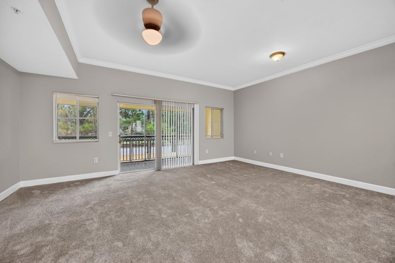 Carpeted living room with sliding glass door at 9745 Touchton Rd, Jacksonville, FL 32246