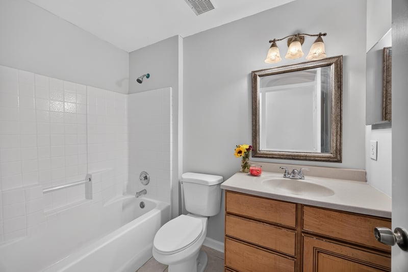 Bathroom with tub shower combo and vanity at 456 Bay Point Way N, Jacksonville, FL 32259