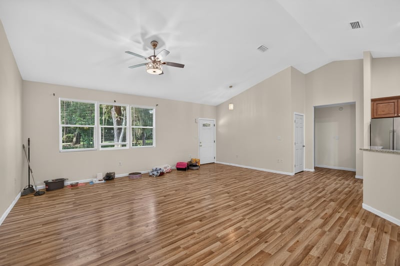Living room with vaulted ceiling and multiple windows at 1012 Fruit Cove Rd, Jacksonville, FL 32259