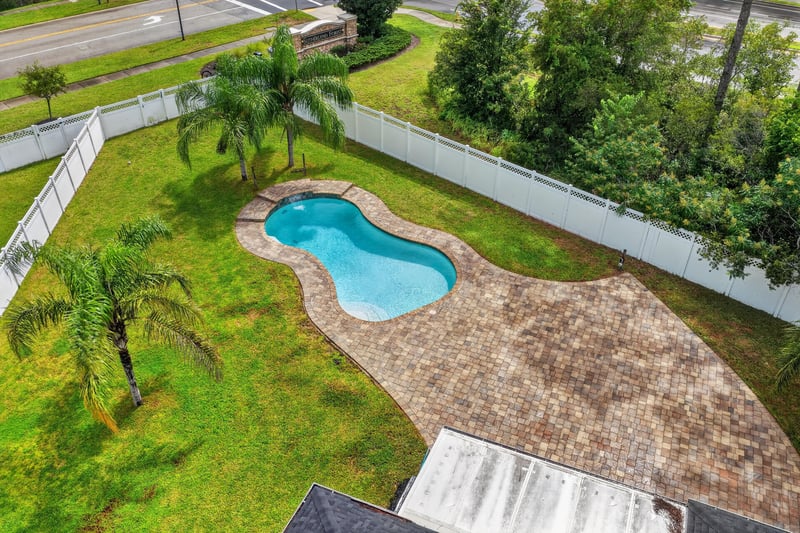 Aerial view of pool and paver patio at 706 Grampian Highlands Dr, St. Johns, FL 32259