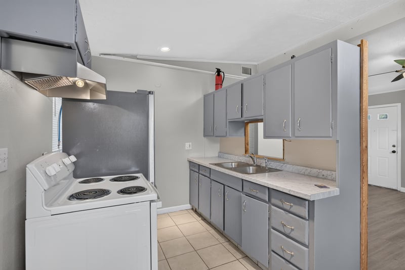 Kitchen with electric stove and gray cabinets at 255 Woodside Dr, Orange Park, FL 32073