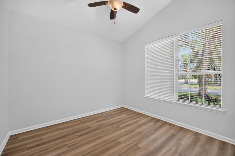 Secondary bedroom with window and wood floor at 3101 E Banister Rd, St. Augustine, FL 32092