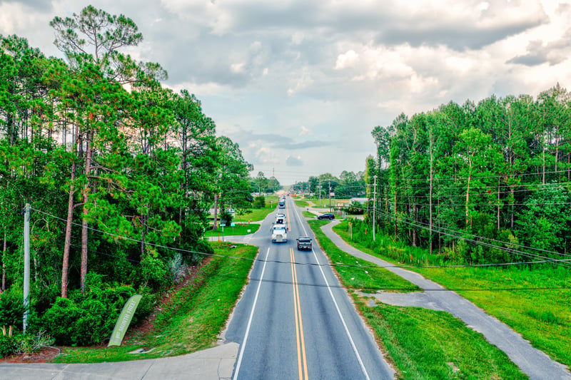 Aerial along the two-lane road with power lines and tree lines at 4393 Co Rd 218, Middleburg, FL 32068