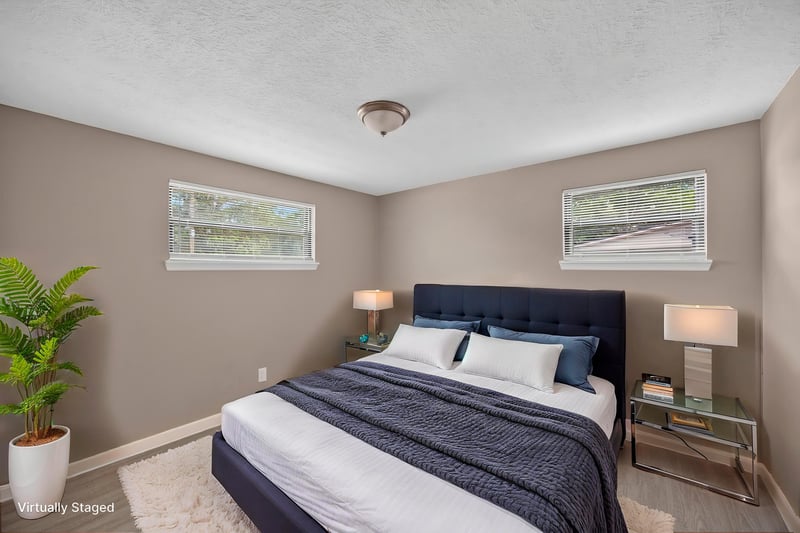 Virtually staged bedroom with potted plant and bed at 184 Draco St, Orange Park, FL 32073