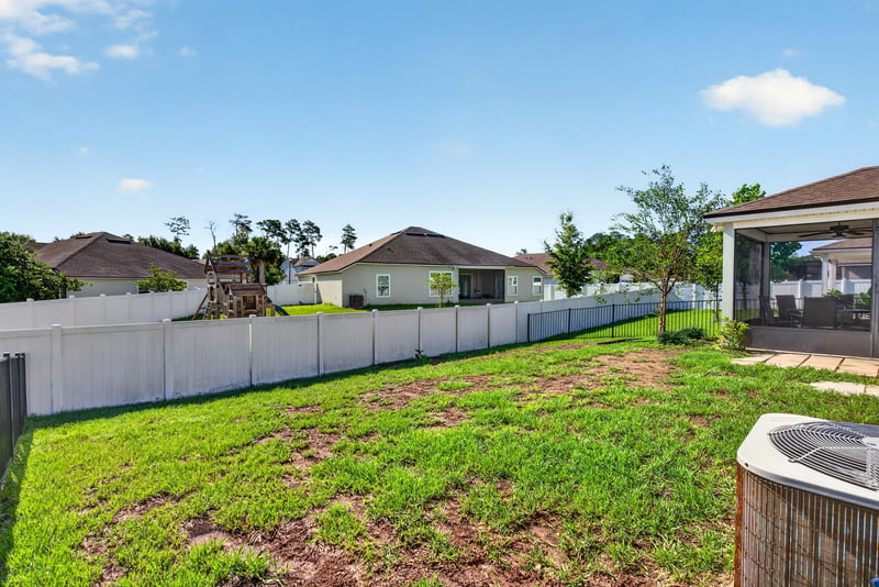 Aerial side yard view with fencing at 589 Seville Pkwy, St. Augustine, FL