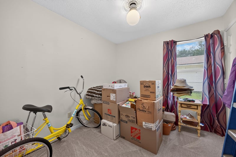 Bedroom with bicycle and storage boxes at 5375 Dodge Rd, Jacksonville, FL 32209