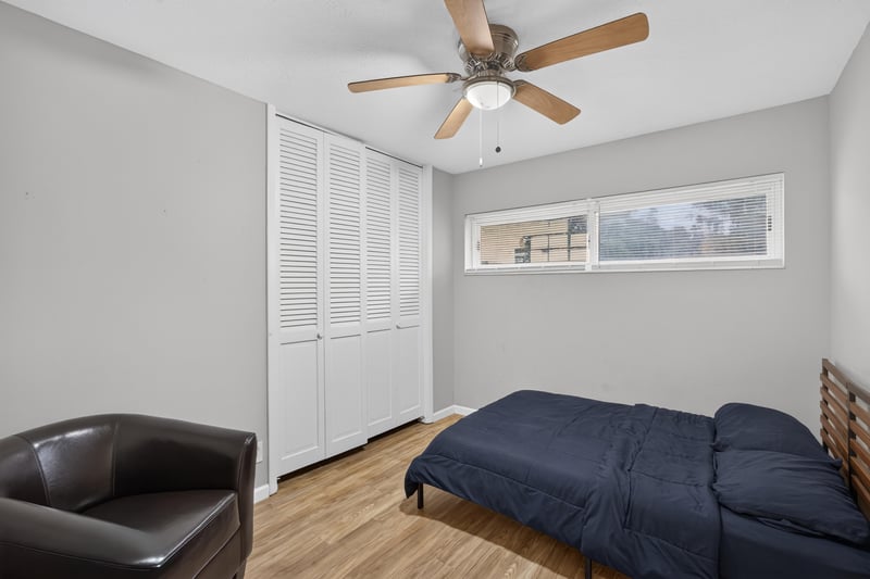 Bedroom with twin beds and closet doors at 9506 Harriet Ave, Jacksonville, FL 32208