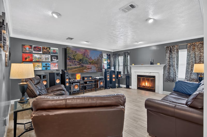 Living room with white fireplace and leather sofas at 6059 Karen St, Jacksonville, FL 32244