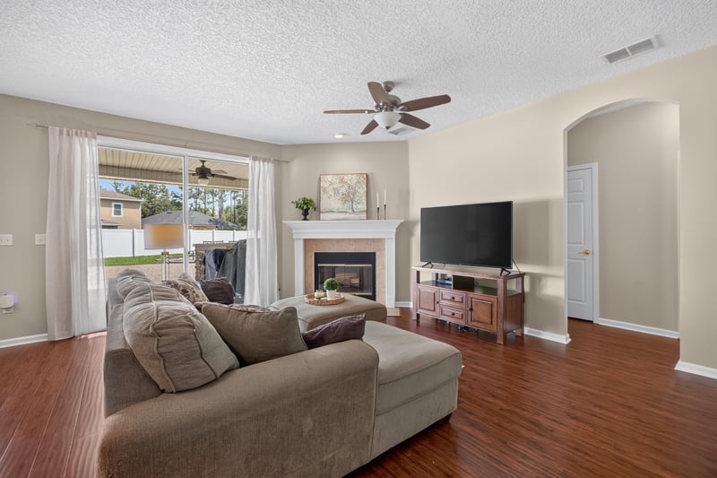 Living room with fireplace and wood floors at 3660 Middlebrook Dr, Orange Park, FL 32065