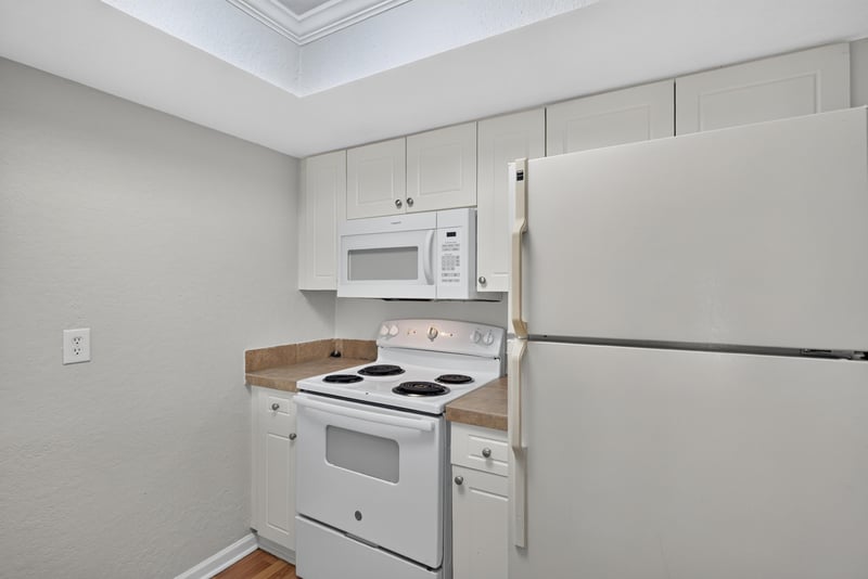 Kitchen with white microwave and refrigerator at 3866 Campenero Ct unit 6, Jacksonville, FL 32217