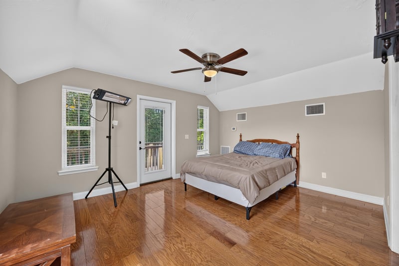 Bedroom furnished with bed and French doors to balcony at 1735 Hagans Ridge Ct