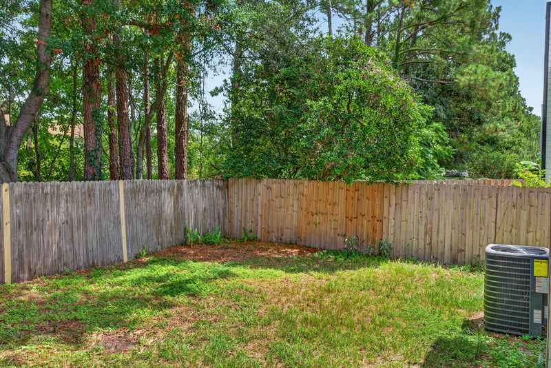 Backyard with fenced yard and trees at 4427 Millstone Ct, Jacksonville, FL