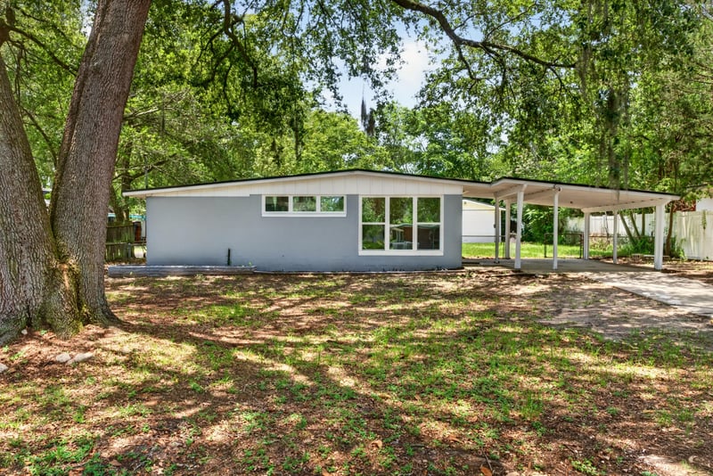 Front exterior view across the front yard at 1928 Montmarte Dr, Jacksonville, FL 32210