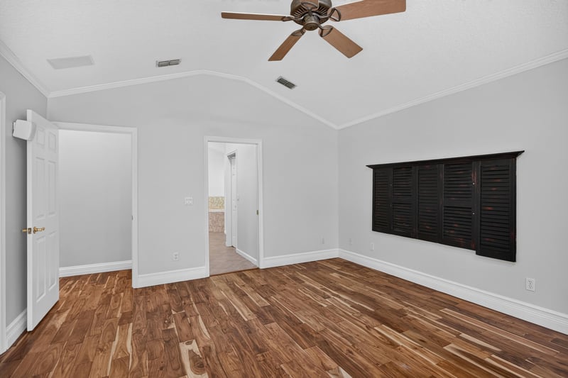 Primary bedroom with window and wood floors at 11675 Magnolia Estates Rd, Jacksonville, FL 32223