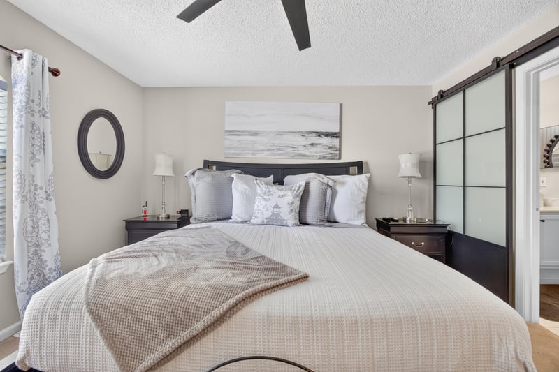 Bedroom with upholstered headboard and barn door at 3067 Wavering Ln, Middleburg, FL 32068