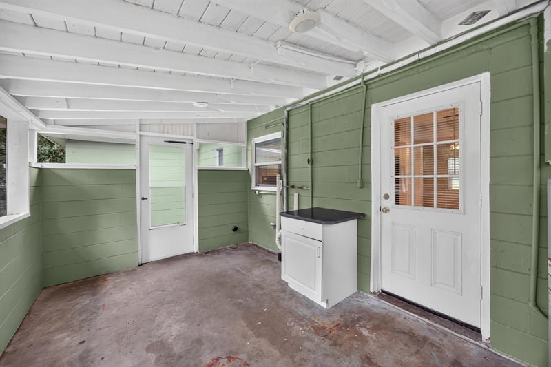 Rear porch, utility area and white door at 2256 Inwood Cir S, Jacksonville, FL