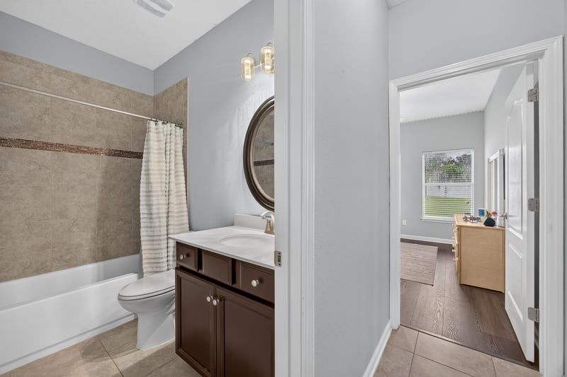 Bathroom vanity with round mirror at 538 Porta Rosa Circle, St. Augustine, FL 32092