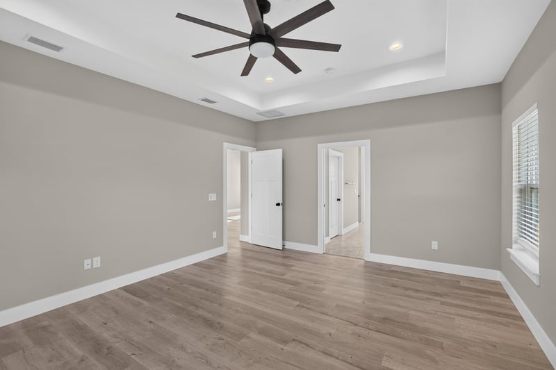 Empty room with tray ceiling and two doors at 175 Alava Ct