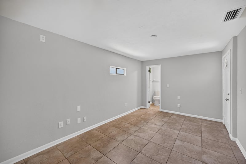 Empty bedroom with carpet and closet door at 7453 Jade Dr N, Jacksonville, FL 32210