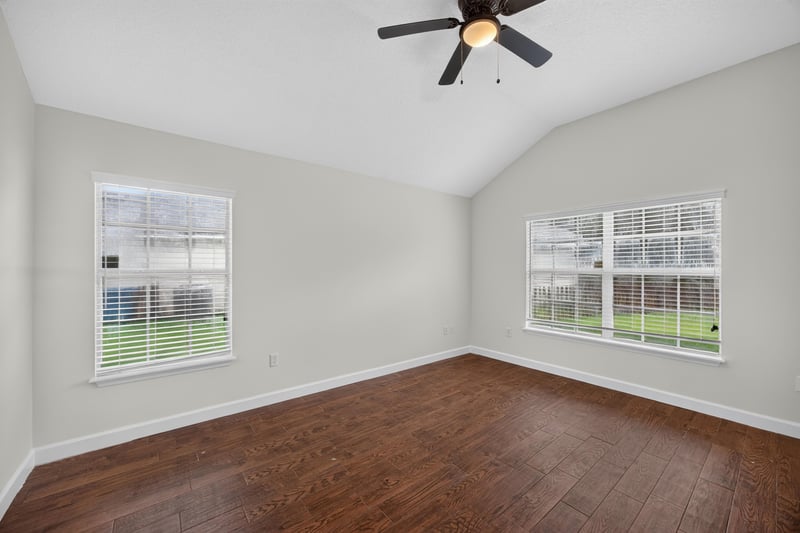 Empty bedroom with vaulted ceiling and wood floor at 706 Bonaparte Dr, Jacksonville, FL 32218