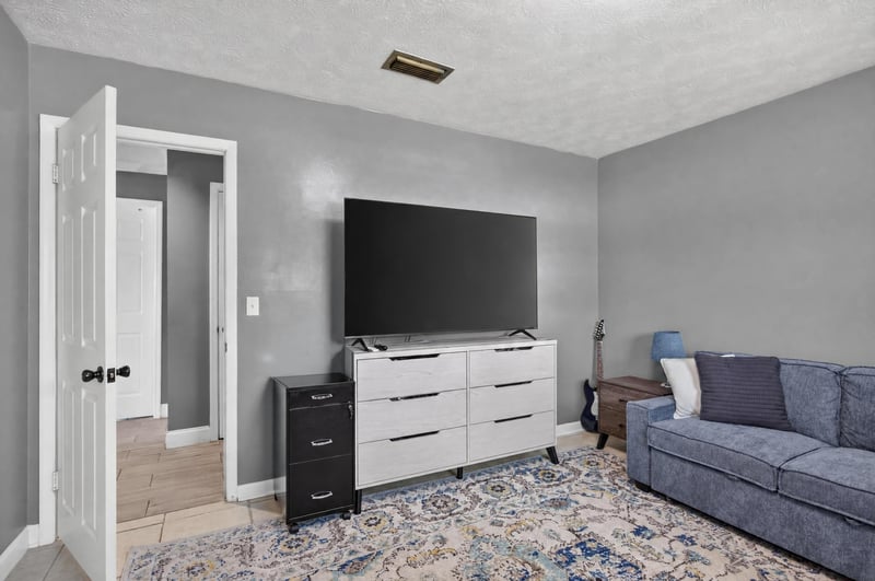 Den area with television and dresser at 6059 Karen St, Jacksonville, FL 32244