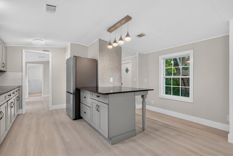 Kitchen island with black countertop at 4565 Appleton Ave, Jacksonville, FL