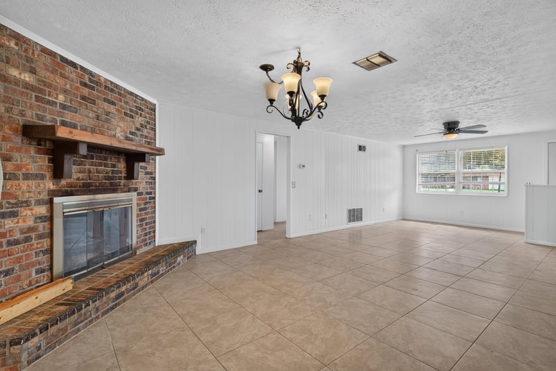 Living room with brick fireplace and chandelier at 9954 Larkdale Ct, Jacksonville, FL 32257