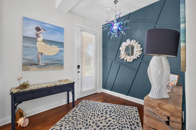 Foyer with blue accent wall and console table at 140 Ave De La Mer, Palm Coast, FL 32137