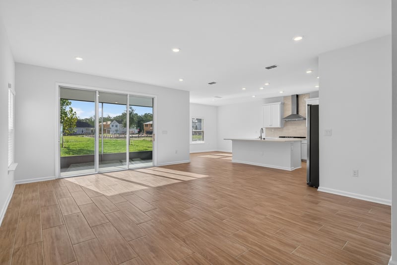 Open living and kitchen area with wood-look flooring at 269 Bluegrass Wy, St. Augustine, FL 32092