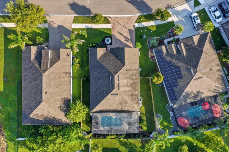 Aerial close-up of the roofline and pool enclosure at 3328 Southern Oaks Dr, Green Cove Springs, FL 32043