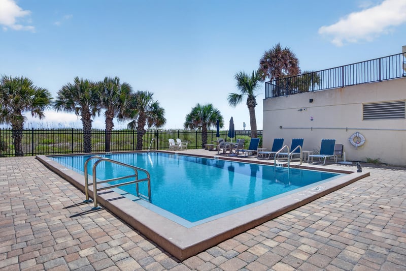 Pool deck with handrail steps at 601 1st St S, Jacksonville Beach