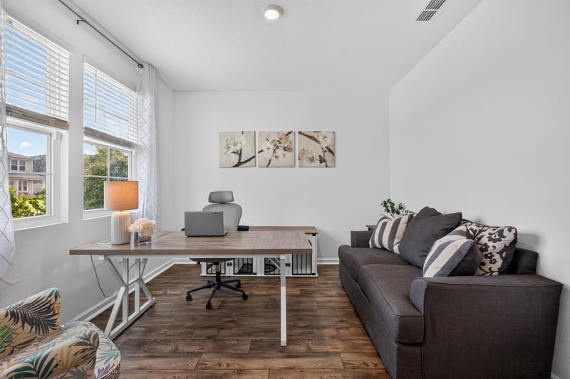 Office area with built-in desk and ceiling fan at 65255 Frst Glen Ln, Yulee, FL 32097