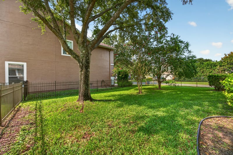 Backyard lawn with trees at 3101 E Banister Rd, St. Augustine, FL 32092